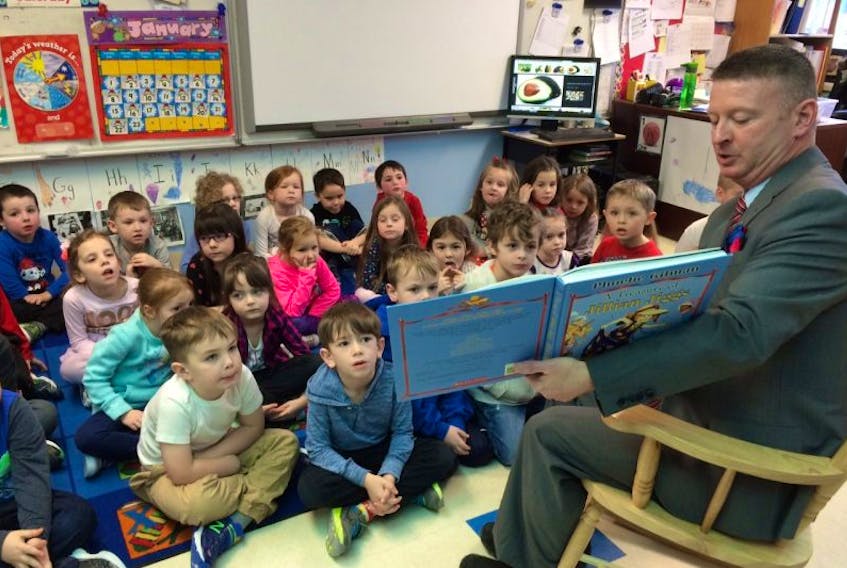 Education Minister Dale Kirby reads to  Kindergarten students in Pouch Cove earlier this year. 