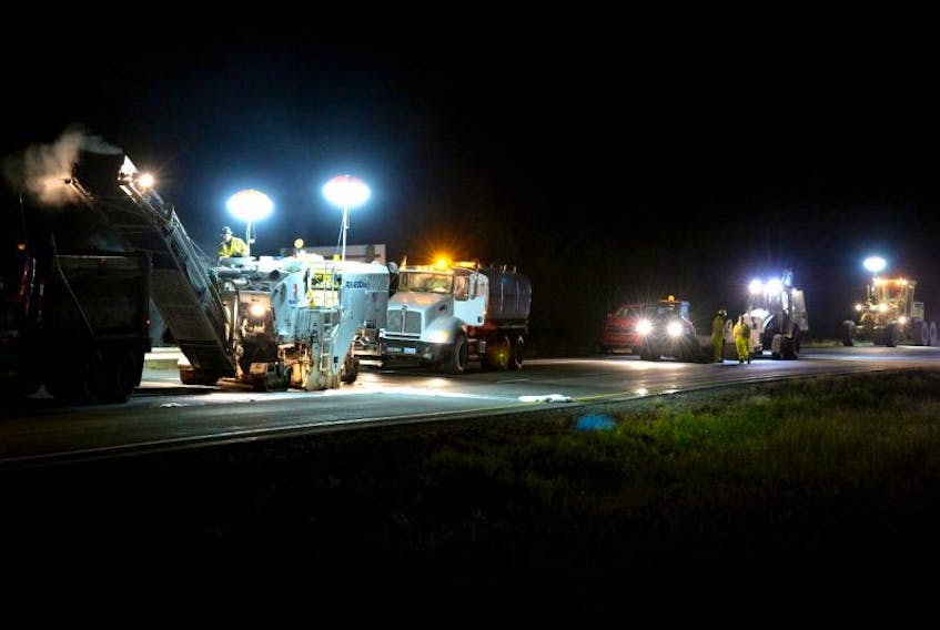 ['Workers and equipment from Concord Paving were on the Trans-Canada highway Monday night to start the province’s first night-time paving project.']