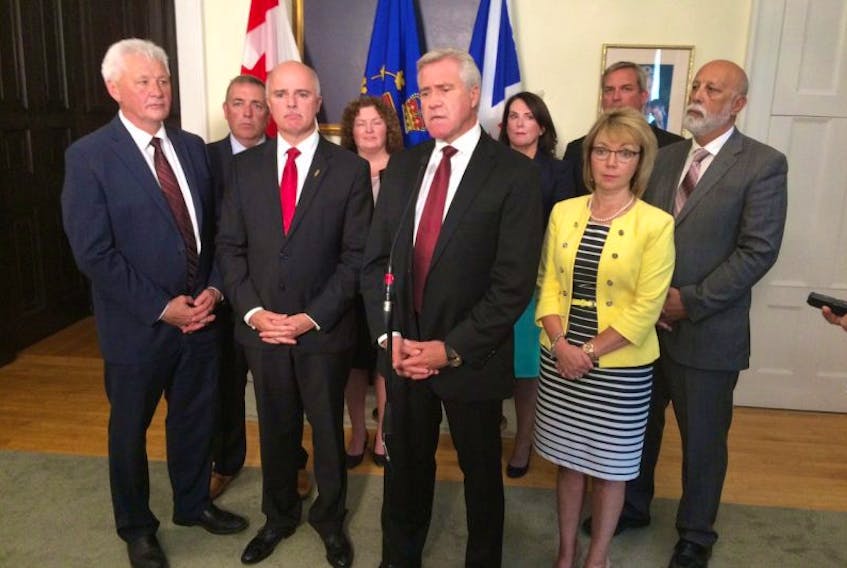 Premier Dwight Ball (centre) speaks to reporters in St. John's Monday following his announcement of a cabinet shuffle. Shown (from left) are Eddie Joyce, Steve Crocker, Tom Osborne, Sherry Gambin-Walsh, Ball, Siobhan Coady, Lisa Dempster, Gerry Byrne and Al Hawkins