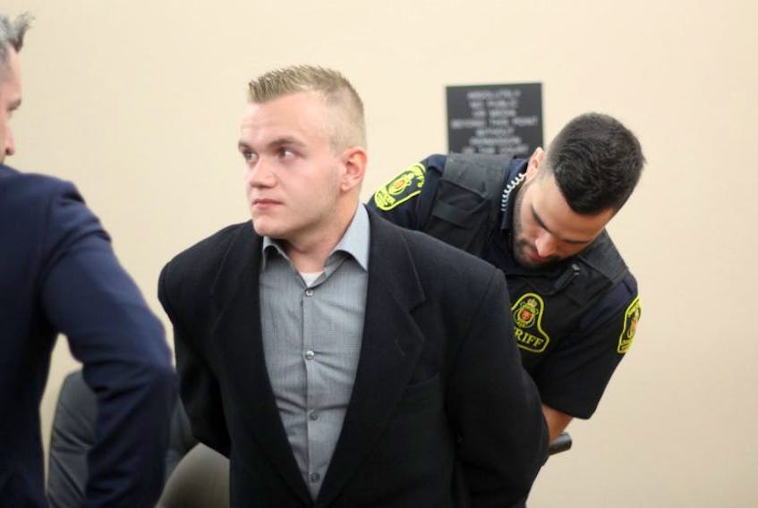 Kyle Morgan looks at his lawyer, Mike King, as he is taken into custody to begin the sentence given to him Tuesday by Judge Colin Flynn. Morgan pleaded guilty to be an accessory after the fact to manslaughter, in connection with the stabbing death of Steven Miller in Conception Bay South last summer.