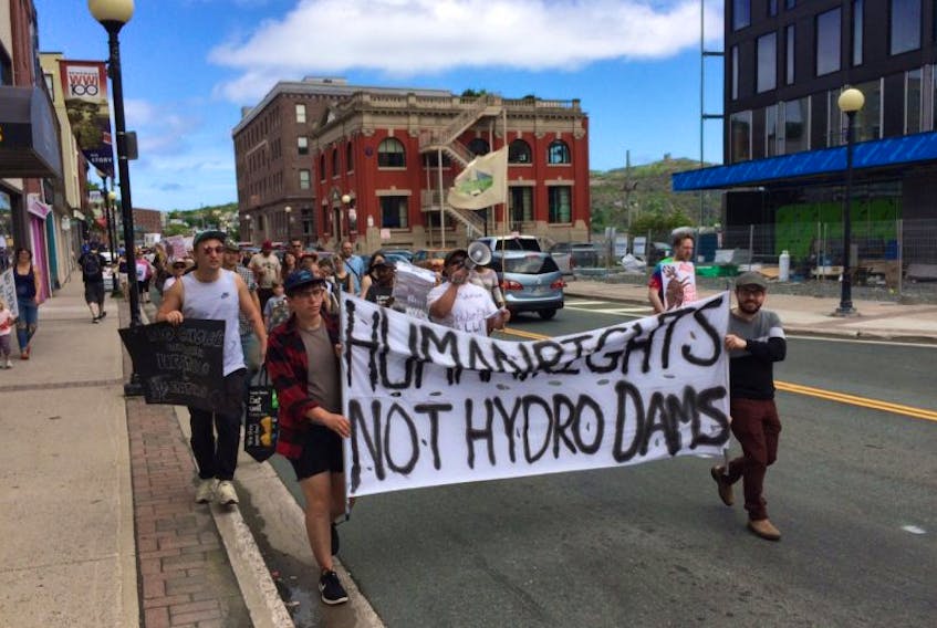 Anti-Muskrat Falls protesters march along Water Street in St. John's Monday afternoon.
