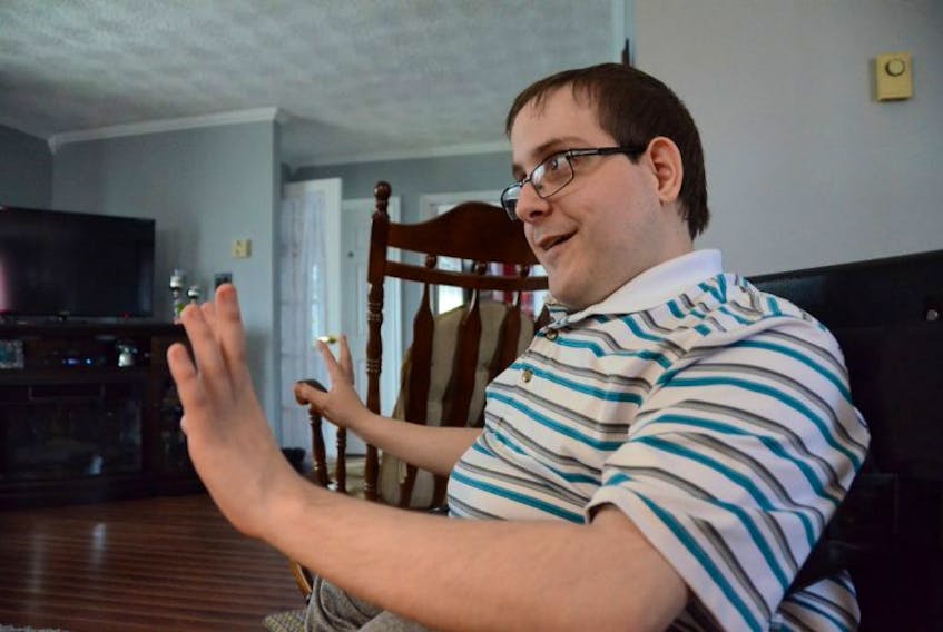 Jonathon Pittman smiles as he talks to The Telegram in his Mount Pearl living room. Pittman’s frustrations about a lack of accessibility in the metro region were published in The Telegram in April. Since then, The Telegram has spoken with many advocates and people with lived experience about inclusion in the province for a series of stories on the subject.