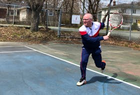 Mike Meaney of Tennis NL follows through on a serve to an imaginary opponent at the Riverdale Tennis Club in St. John's Monday.  Peter Jackson/Local Journalism Initiative reporter