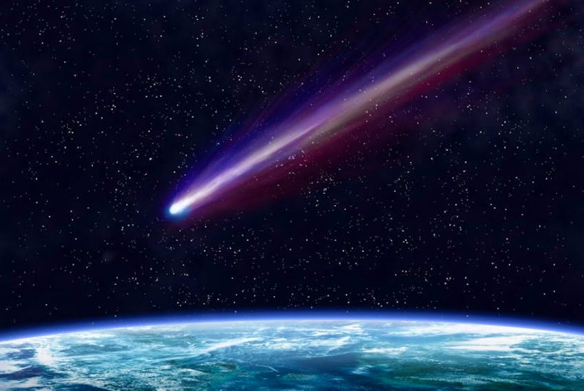 A bright comet crosses the night sky.