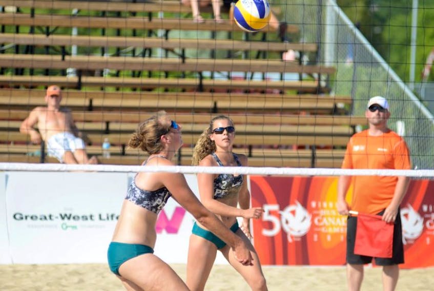 Haley Wilting, left, sets Laura Ready during Sunday's Canada Games beach volleyball competition.