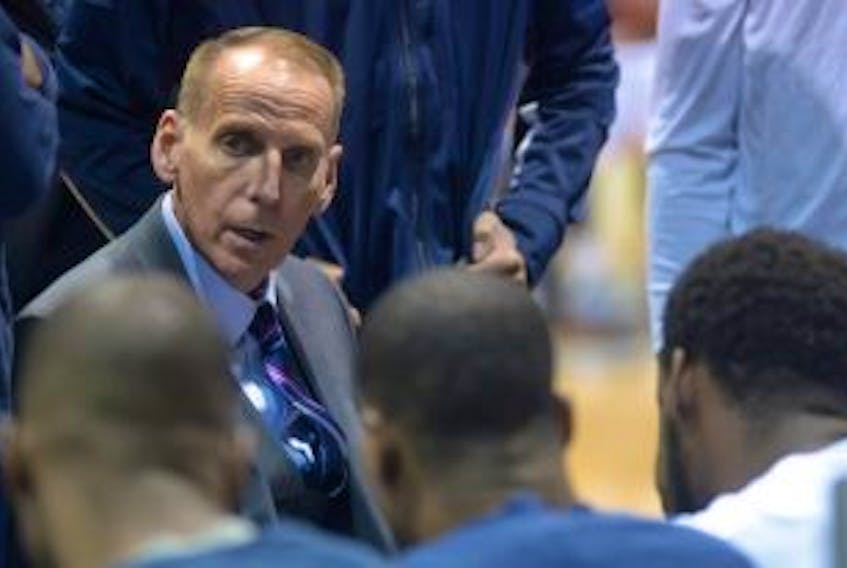 ['Halifax Hurricanes head coach Mike Leslie speaks with his players during a timeout Thursday at the Eastlink Centre.']