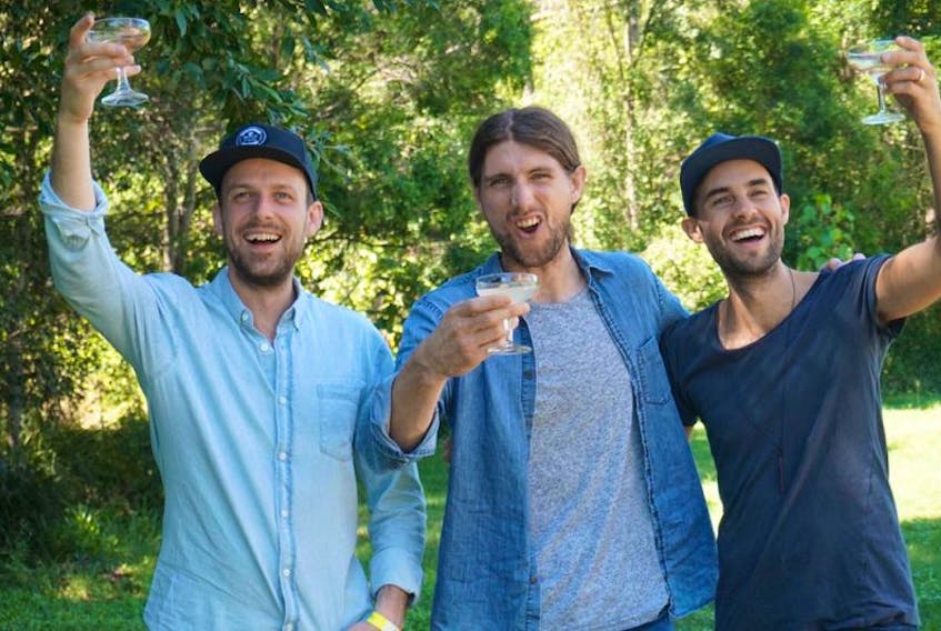 East Pointers members from left, guitarist Jake Charron, banjoist Koady Chaisson (with a ginger beer) and fiddler Tim Chaisson and  give a cheers after finding out they won the JUNO award for Traditional Roots Album of the Year with their full-length debut “Secret Victory” this weekend. The group is in the middle of a two-month tour in Australia.