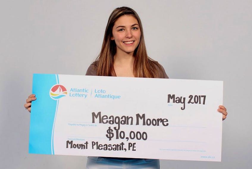 Meagan Moore of Mount Pleasant holds a symbolic cheque showing her recent $10,000 win with a Scratch’N Win Alpha ticket. She plans to use the money to pay down her student loan. She graduated this year from UPEI with a Bachelor of Arts degree.