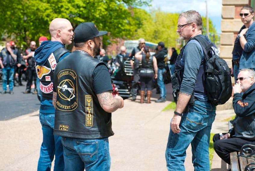 RCMP Cpl. Andy Cook, who is also provincial outlaw motorcycle gang (OMG) co-ordinator, speaks with some bikers before the start of the Atlantic Confederation of Clubs "unity rally' Saturday in front of Province House.