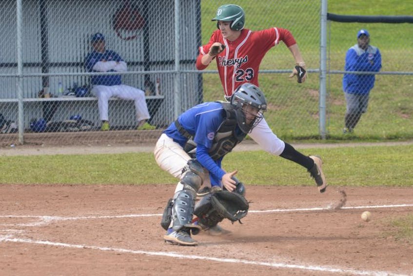 Josh Myers scores ahead of the throw Sunday as the Summerside Team One Chevys play the Fredericton Royals at the Atlantic midget baseball championship in Stratford.