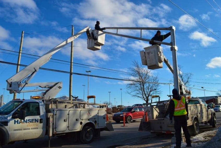 City workers install new traffic lights on Kensington Road. 