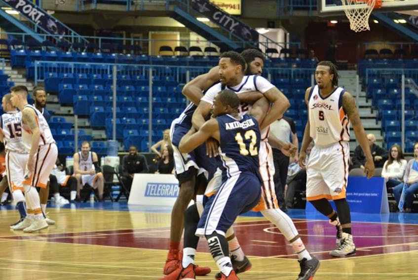 Island Storm guard Rashad Whack, centre, tries to work through an Anthony Stover screen while defending Riptide guard Anthony Anderson Thursday in Saint John, N.B.