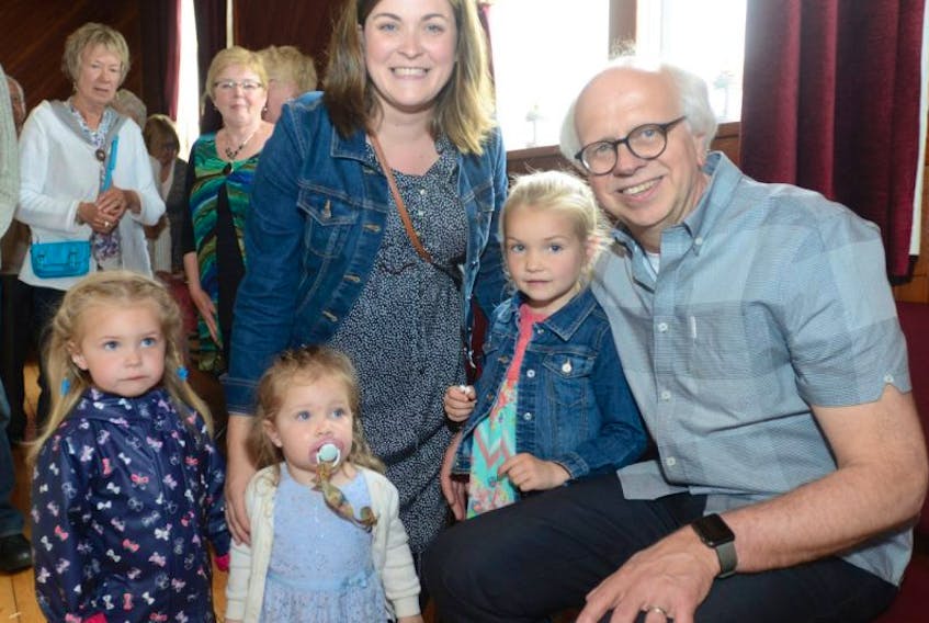 Dr. Henk Visser, right, is thanked by some of his youngest patients, from left, Emily, Audrey and Lilly MacFadyen and their mother Crystal MacFadyen during a farewell party held by the community surrounding Crapaud on Sunday. After finding a successor to his general practice, Dr. Visser has retired following 32 years of providing care to thousands of patients in the community.
