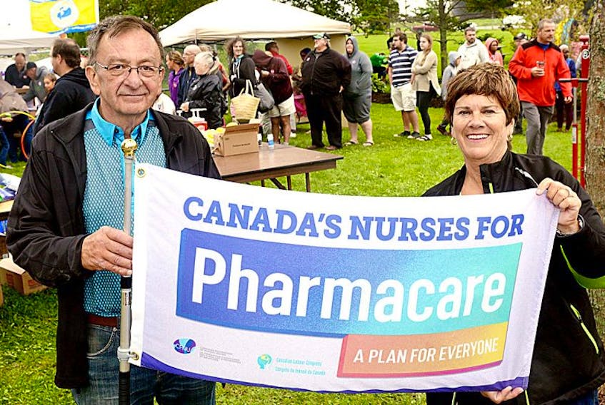 Carl Pursey, president of the P.E.I. Federation of Labour, and Mona O’Shea, president of the P.E.I. Nurse’s Union, hold up a flag advocating for a national pharmacare plan during the Labour Day picnic at Joe Ghiz Park on Monday. More information on the “A Plan For Everyone” campaign, which is a collaboration between the Canadian Federation of Nurses Unions and Canadian Labour Congress, as well as a petition can be found on the website www.aplanforeveryone.ca.