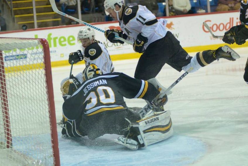 Charlottetown Islanders left-winger Alex Dostie, left, is stopped by Cape Breton Screaming Eagles goalie Kyle Jessiman during Friday's game at the Eastlink Centre.
