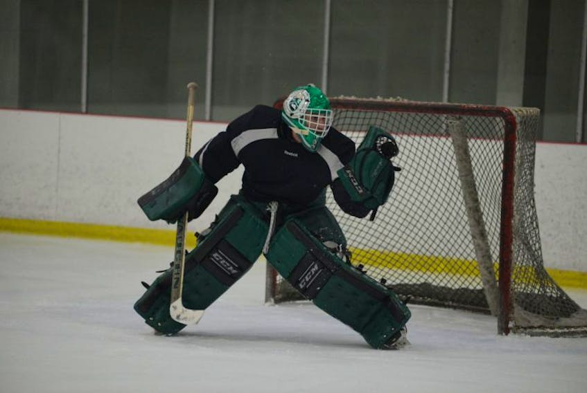 Matt Mahalak makes a glove save during practice in the 2016-17 UPEI men's hockey season.