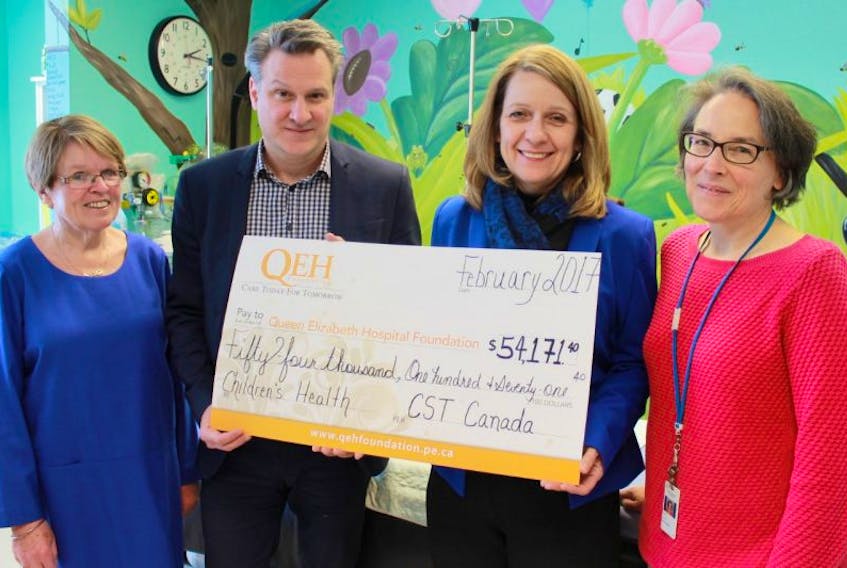 Dr. Barbara Flanagan, left, chairwoman of the QEH Foundation’s annual Friends for Life Campaign, and Philippe Lagacé and Dale Eustace of CST Canada Co. present Dr. Kathryn Bigsby, pediatrician at Queen Elizabeth Hospital, with a donation of $54,171 toward the new cardio-respiratory central monitoring system in the Pediatric Unit of the QEH.