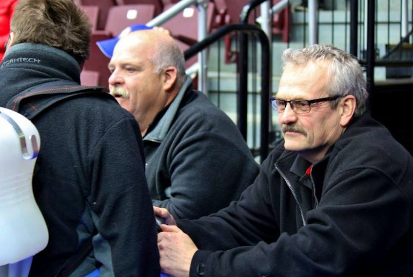 Larry Richards, right, is part of the ice crew at the Tim Hortons Brier in St. John's, N.L.