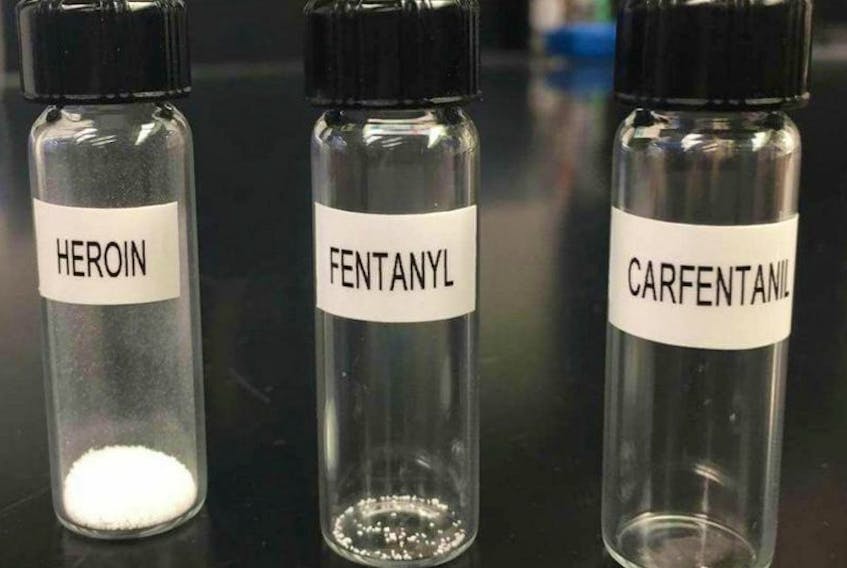 A police handout photo shows the decreasing amount of heroin, fentanyl and carfentanil in a vial that is enough to kill a person.
