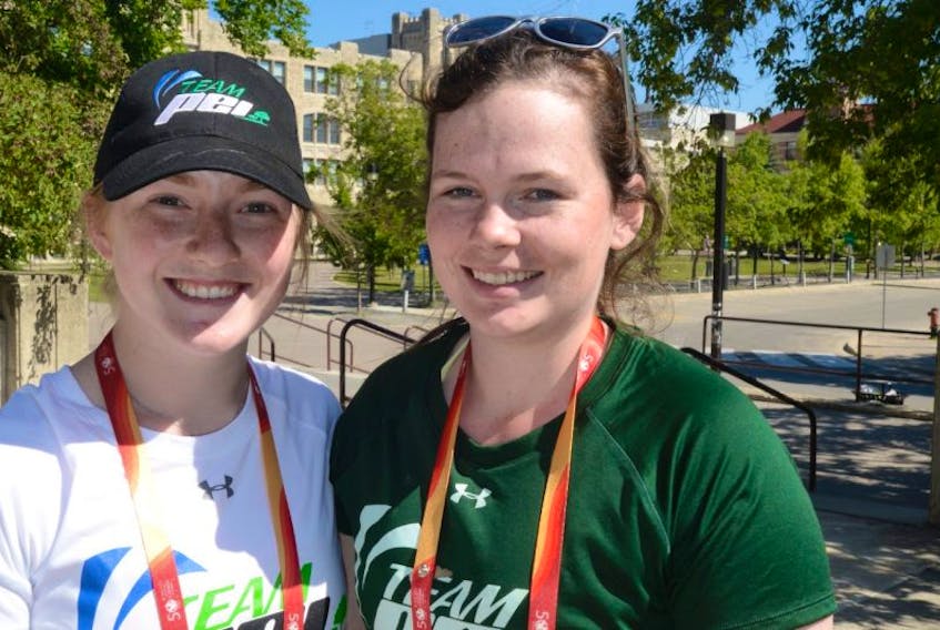 Emily Brothers, left, and Katie Rayner and their Team P.E.I. softball teammates are ready to play their first game today at the Canada Games in Headingley, Man.