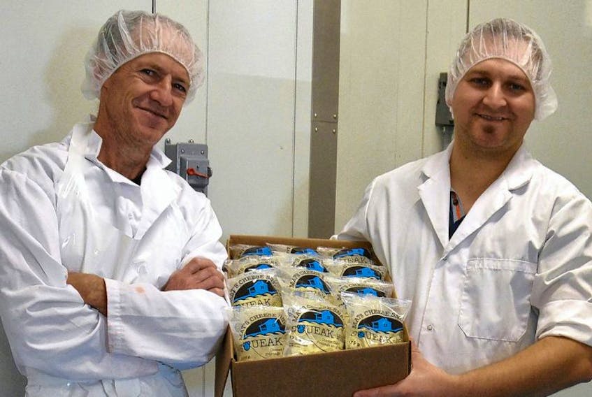 Albert Arsenault, the cheese maker, and Mathieu Gallant, the owner of The Island Artisan Cheesehouse, hold a box of Squeak-ies.