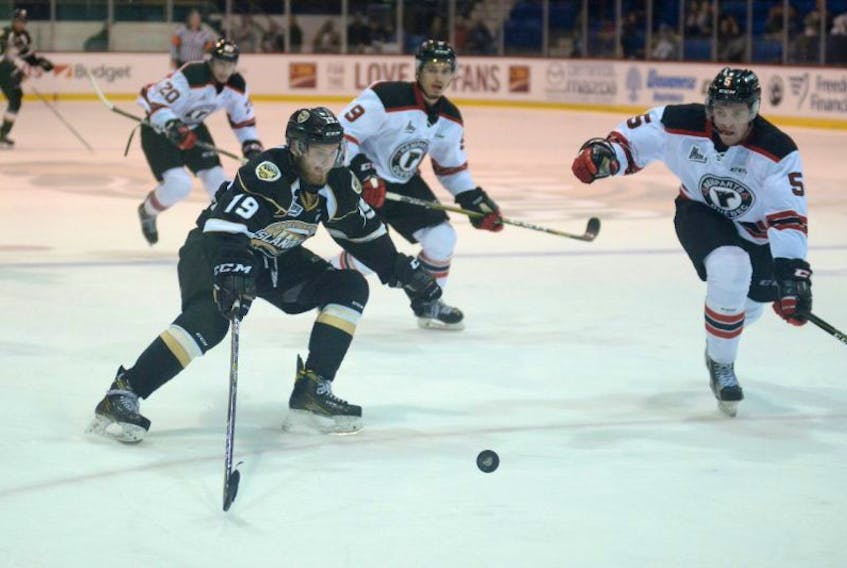 Charlottetown Islanders winger Adam Marsh, left, prepares to try and tip the puck past Quebec Remparts defenceman Sam Dunn Saturday at the Eastlink Centre.