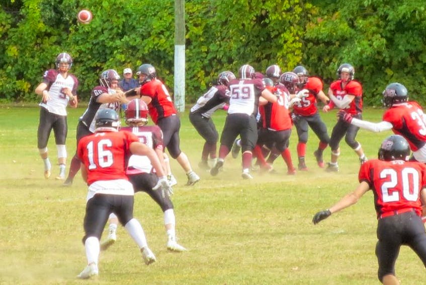 Holland College Hurricanes quarterback Brady Crowe completes a pass to receiver Tyler Majuray during Saturday’s Atlantic Football League contest in Fredericton, N.B.