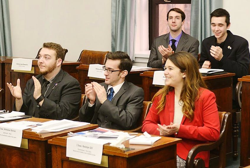 Participants in a Francophone youth parliament from left, Daniel Boutin, Nicholas Doiron and Katelyn Gill, take part in one of the mock debates held at the Coles Building this weekend. The three-day exercise allowed youth to explore both light-hearted and heavy topics in an environment that accurately mirrored parliamentary debate.