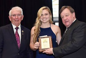 Charlottetown Rural student Alison Muise receives the 20th annual David Eli MacEachern Scholarship from Lt.-Gov. Frank Lewis, left, and Charlottetown Mayor Clifford Lee.