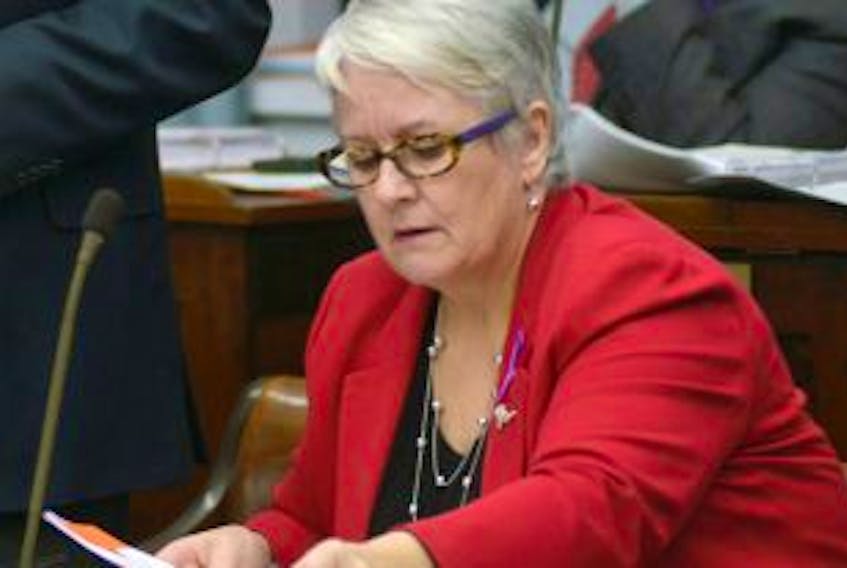 ['Transportation Minister Paula Biggar checks some papers during a recent session of the legislature. She has announced that drivers who are repeatedly caught driving drunk or on drugs will soon face some tougher penalties.']