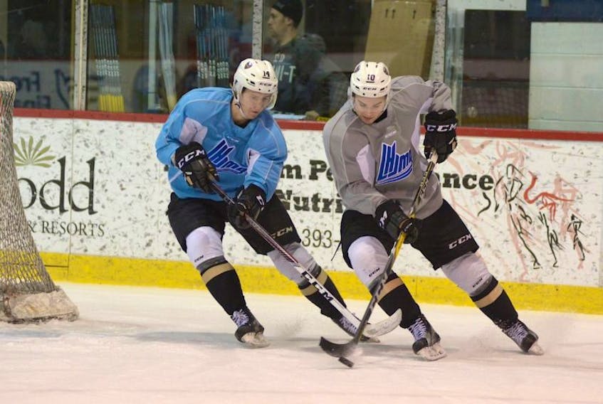 Charlottetown Islanders forward Filip Chlapik, left, and Kameron Kielly battle for the puck during Tuesday's practice.