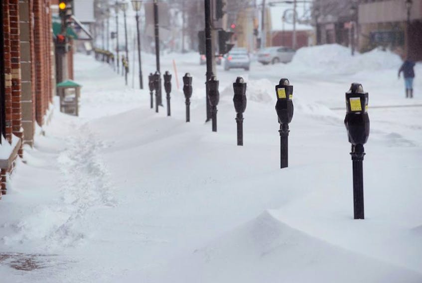 Meters are all lined up in the snow with no one to feed them as snow clearing operations for parking spaces took a back seat to snow removal on main streets this morning.