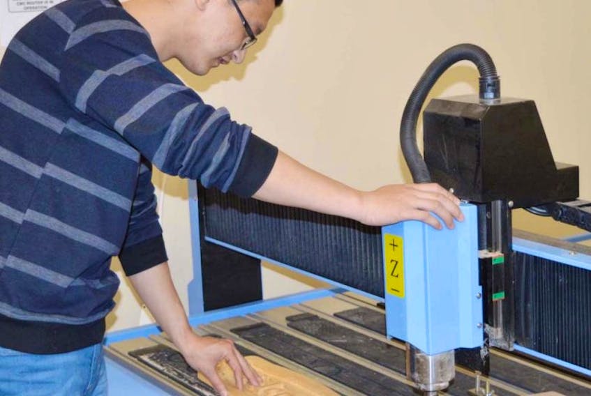 Ben Bing, a tech with SignCut in Stratford, does some engraving on the CNC router. While the business does make signs, it also sells these machines.