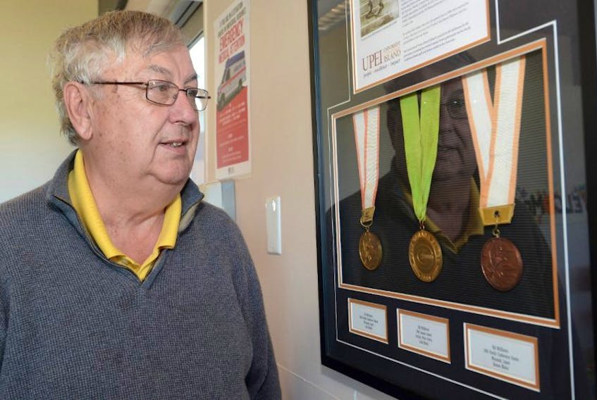 Bill McKinnon looks at his medals on display at the track clubhouse at UPEI Alumni Canada Games Place. They include the first medal won by an Island athlete at the Canada Games.