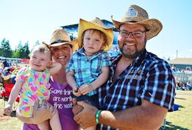 Brenda and Carl Moore with their two children, Frankie, 1, and Parker, 2.5, on Sunday at the Cavendish Beach Music Festival. Brenda, who is five months pregnant, was also pregnant with Frankie and Parker in previous years at the festival.