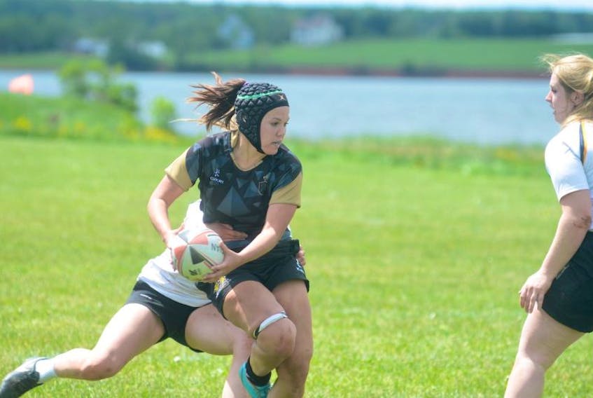 Charlottetown Rugby Football Club flankerMegan Larkin looks for a teammate to pass to Saturday during women's rugby action at Co-Op Field in Charottetown against the Nova Scotia under-20 Keltics.
