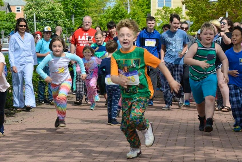 Youngsters lead the way during the first lap of the Rise and Shine PJ Walk in support of Ronald McDonald House at Confederation Landing on Sunday. The inaugural event raised funds to support Maritime families with sick children and saw former NHL star Brad Richards as an honorary chair.