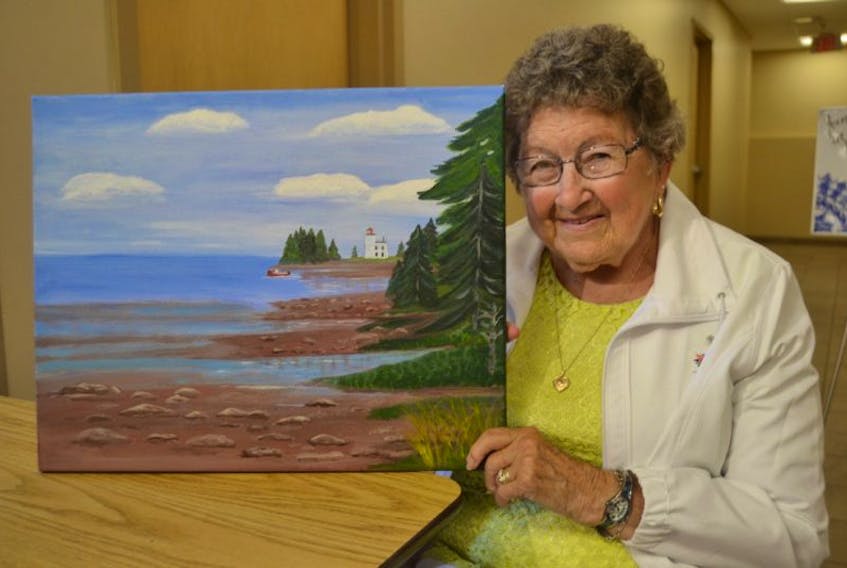 Millie Kikkert shows her painting, “Blockhouse”. The 85-year-old New Haven artist is the driving force behind Millie’s Marvels, a group of women who get together for painting and fellowship at Burnside Presbyterian Church on Tuesday mornings. Their group art show is currently on view at the Cornwall Public Library art gallery.