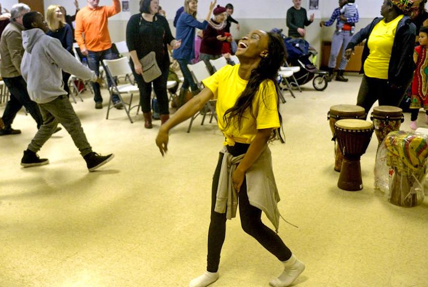 Fisayo Honboulo, originally from Nigeria, smiles while teaching a group of Islanders how to perform an African dance during a workshop held by the Maritime Centre for African Dance in Charlottetown Saturday night. The group aims to promote cultural awareness through dance and is hoping to secure a P.E.I. location next month to continue offering workshops and lessons.