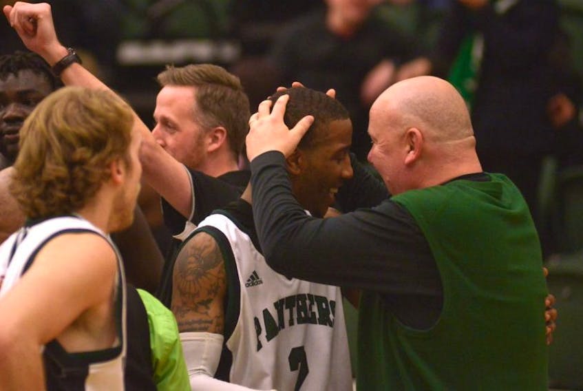 UPEI Panthers head coach Tim Kendrick, right, congratulates Tyler Scott after winning his final home game at UPEI.