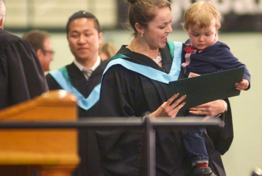 UPEI graduate Rose Leger and her son Darien check out her Bachelor of Education while walking across stage during the university’s convocation ceremony Saturday morning. Leger, of Charlottetown, was also awarded the Faculty of Education Prize during the ceremony.