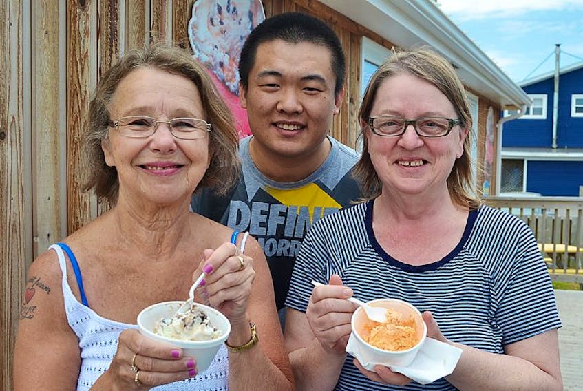 The warmer weather brought Dorothy Allen, left, and Della Forsythe out to Seawalk Scoops in North Rustico to have their first taste of summer ice cream. Owner Linyo Chung says that Seaside Carmel and Grizzly Tracks are the top picks so far. "We had so many orders for Grizzly Tracks we ran out," he said. The store is part of the Sea Walk shops.