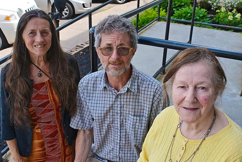 Activists Sharon Labchuk, left, Tony Reddin and Mary Boyd gather for a photo after meeting with Environment Minister Robert Mitchell in Charlottetown this week.