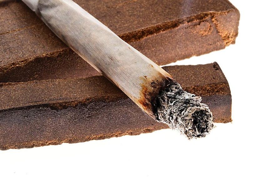 FILE PHOTO: Picture of a lit joint laid on two pieces of hashish. The photo is not from the case mentioned in the story and is for illustration only.