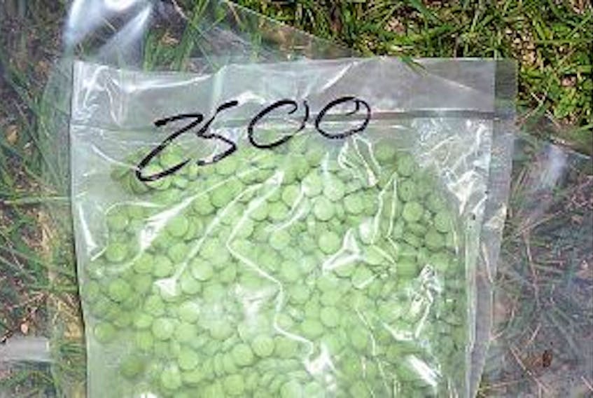 ['PLEASE CLICK PHOTO TO SEE LARGER IMAGE: A package of illegally manufactured pills seized recently on P.E.I. during raids by the RCMP. The pills are made to look like Oxycontin 80 mg medication, but they also contain hidden Fentanyl.']