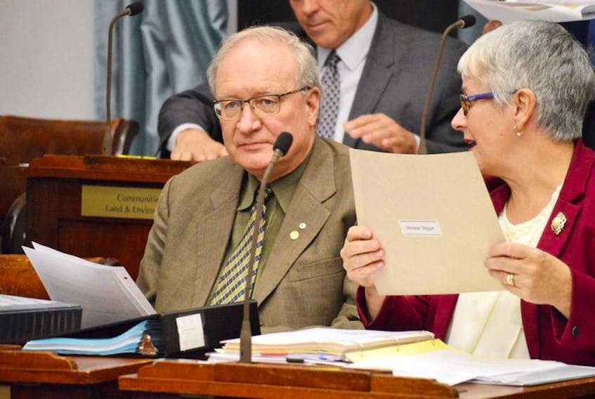FILE PHOTO: Premier Wade MacLauchlan and Transportation Minister Paula Biggar discuss government business before the start of ta recent session of the P.E.I. legislature.