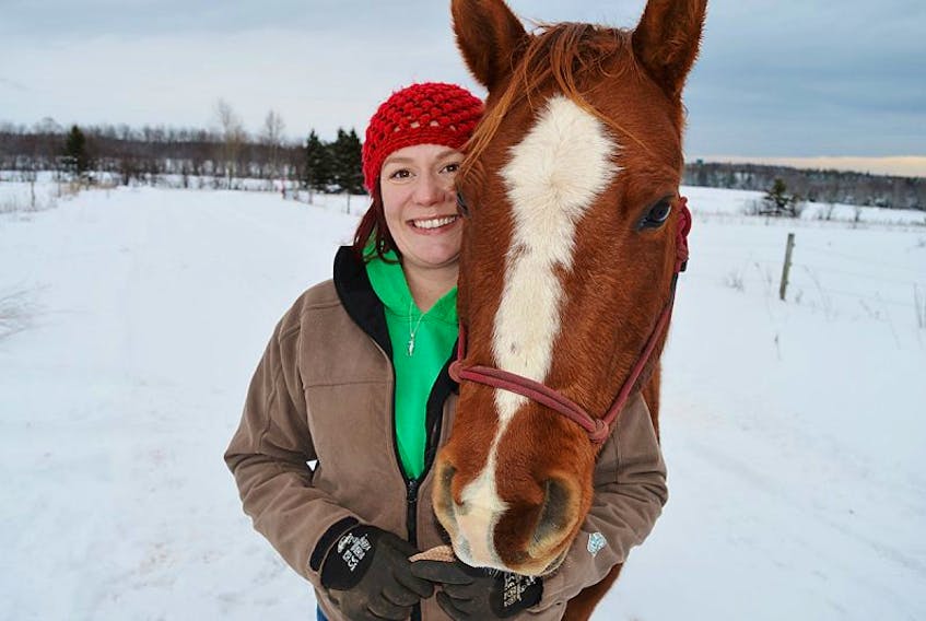 Ellen Jones, pictured here with Ginger, is hoping that negotiations with the provincial government on the sale of her farm go well enough to enable her to relocate the therapeutic operation close by.