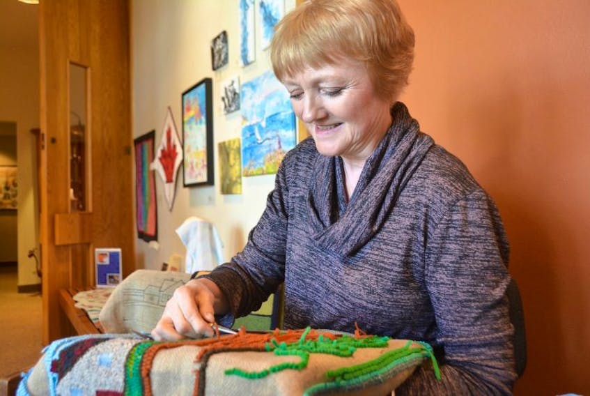 Betty Young demonstrates her rug hooking abilities during a demonstration day at the Eptek Centre in Summerside.