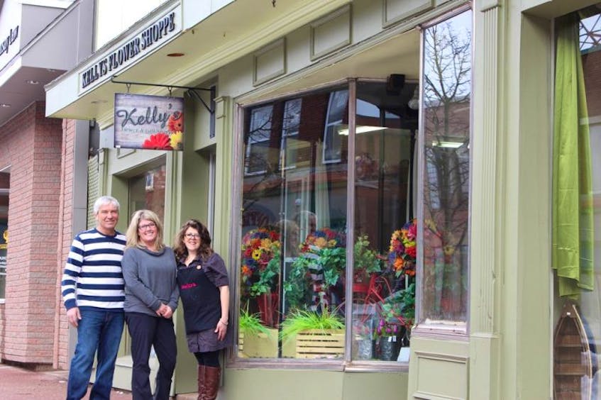 Donnie MacArthur, left, Cindy Robichaud and Elise Arsenault stand outside the storefront of Kelly’s Flower Shoppe in Summerside at 297 Water Street. The store will move to 505 Granville Street and is set to open April 3.