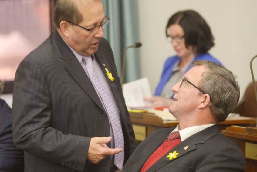 Workforce and Advanced Learning Minister Sonny Gallant, left, speaks with Fisheries and Agriculture Minister Alan McIsaac before question period in the P.E.I. legislature on Tuesday. 